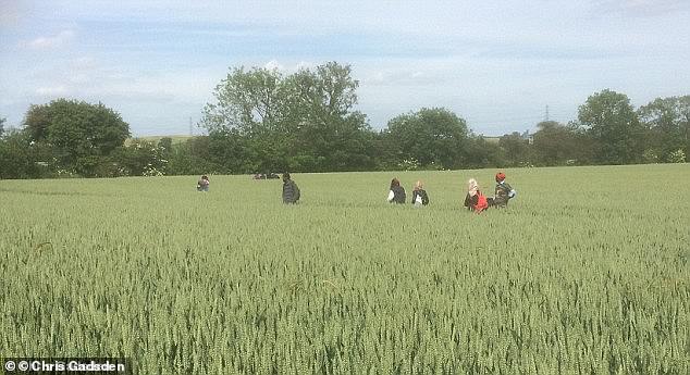 Photos of migrants on Chris's farm show them trekking through his crops
