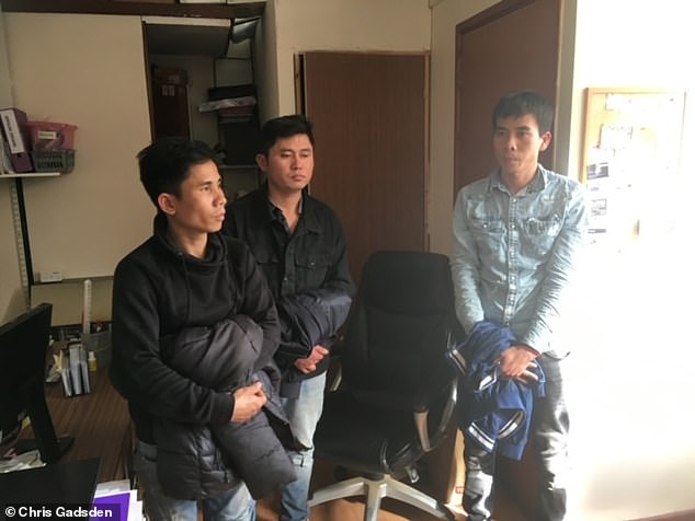 A group of men wait for the police in Chris' office. When he escorted immigrants back to his house, Chris said he gave them food and water as they waited for the authorities