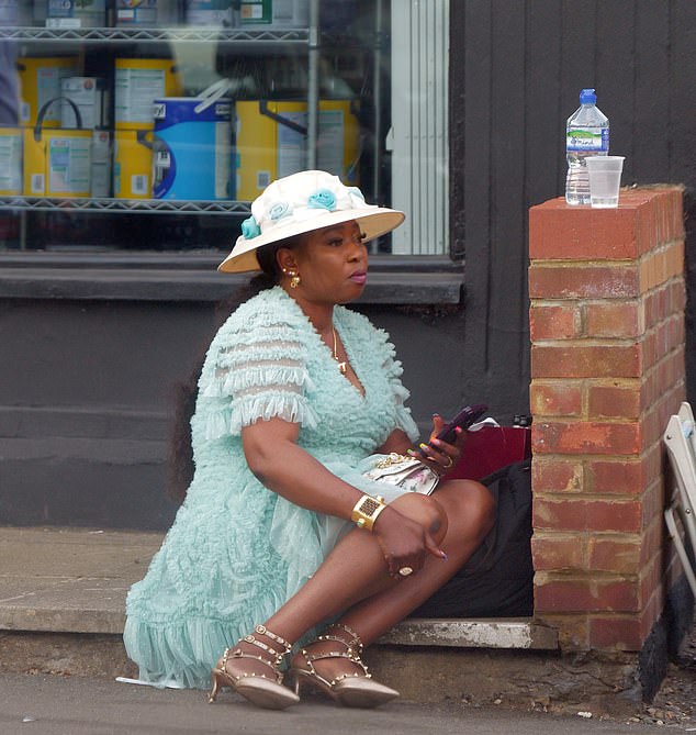 One lady takes a moment to get off her heels as she takes a perch on a step