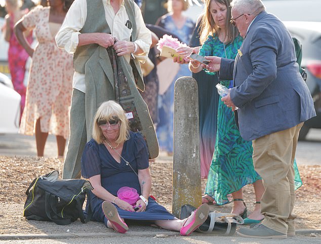 One punter takes the opportunity to rest her feet after a day of racing