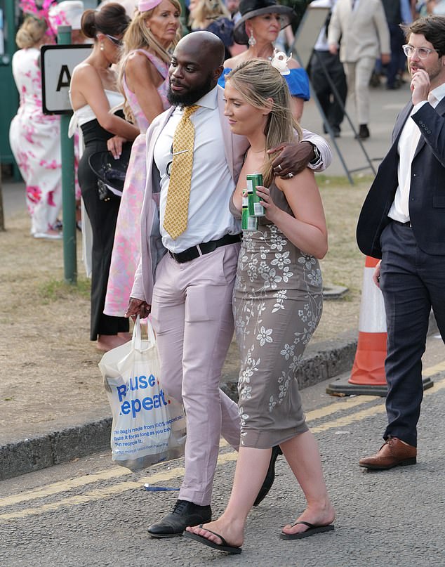 A couple start their walk home after a long day at Ascot