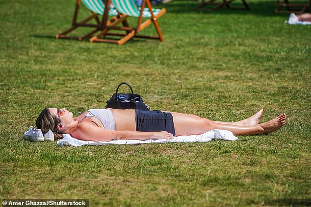 Although many will be looking forward to enjoying the weather, temperatures exceeding 28°C (82.4°F) can be dangerous, especially for elderly people. Pictured: A woman sunbathes at St James's Park in London today as temperatures begin to rise