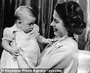 Queen Elizabeth II is pictured holding Charles in 1949