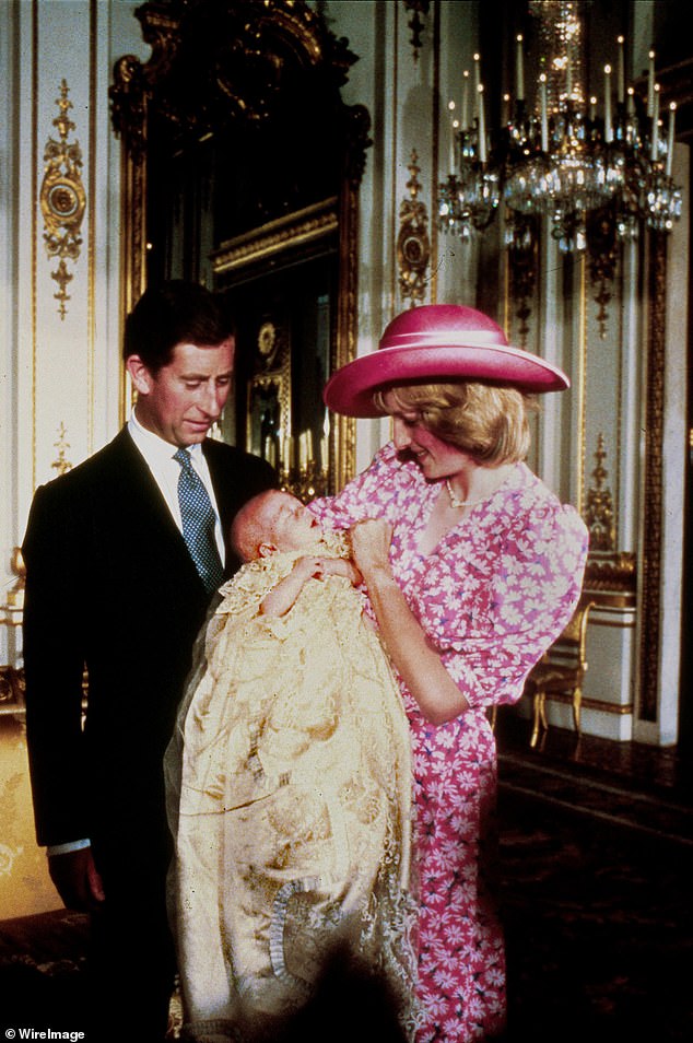 Diana holds baby Prince William as Charles looks on during the christening of William in the Music room at Buckingham Palace on August 4, 1982