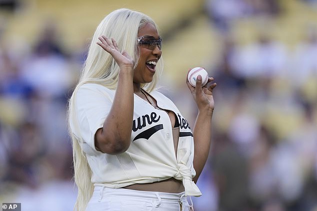 The star flashed a big smile as she paused for a quick snap on the field
