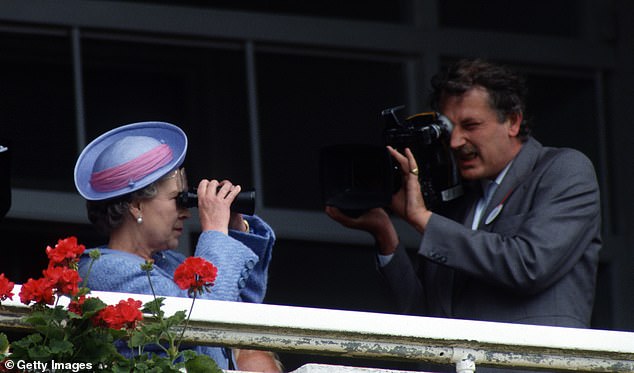 Queen Elizabeth ll is filmed for a BBC television programme as she watches racing at the Epsom Derby