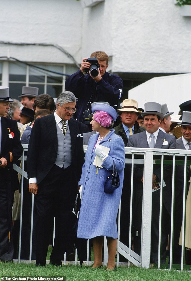 Photographer Tim Graham is photographed taking a picture of the Queen at the 1991 Derby