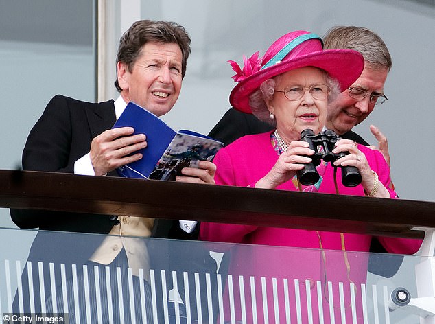 Queen Elizabeth II, accompanied by her racing manager John Warren, watches the racing as she attends at Derby Day of the 2008 Derby Festival at Epsom Racecourse