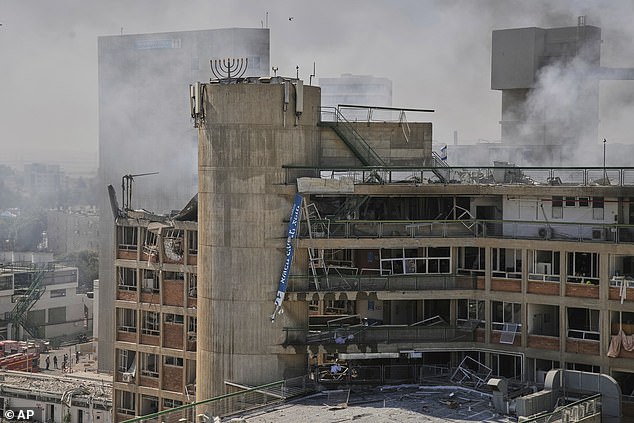 Pictured: Smokes rises from a building of the Soroka hospital complex after it was hit by a missile fired from Iran