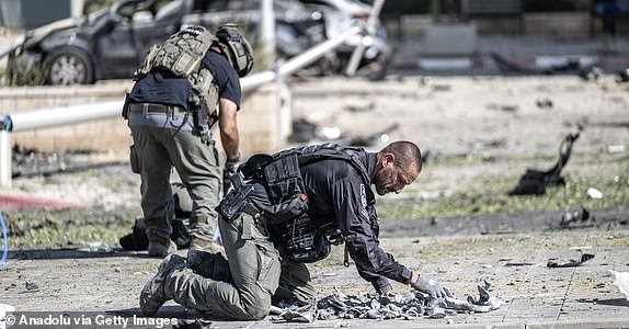 BEERSHEBA, ISRAEL - JUNE 20: Israeli police officers and bomb disposal experts are seen working at the impact site after a missile reportedly launched from Iran struck the southern Israeli city of Beersheba on June 20, 2025. Authorities began investigations following the incident as part of broader security measures amid ongoing regional tensions. (Photo by Mostafa Alkharouf/Anadolu via Getty Images)