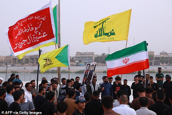 Supporters of Iraq's Hezbollah Brigades attend a gathering to condemn Israel's attack on Iran in the city of Nasiriyah, in Iraq's southern Dhi Qar province on June 19, 2025. (Photo by Asaad NIAZI / AFP) (Photo by ASAAD NIAZI/AFP via Getty Images)