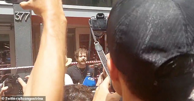 A hotel worker in Barcelona is seen confronting antitourism protesters to tried to cordon off his place of work