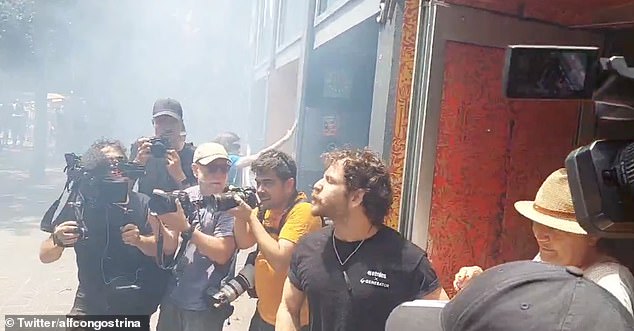 The worker was heard telling protesters he was 'only working'