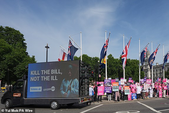 An ad van in opposition to the assisted dying Bill passes Dignity in Dying campaigners in Parliament Square, central London, ahead of a debate on the Terminally Ill Adults (End of Life) Bill in the House of Commons. Picture date: Friday June 20, 2025. PA Photo. Photo credit should read: Yui Mok/PA Wire