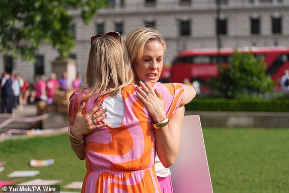 Dame Esther Rantzen's daughter Rebecca Wilcox with campaigner and cancer sufferer Sophie Blake (back to camera) supporting the Dignity in Dying protest in favour of the assisted dying Bill, in Parliament Square, central London, ahead of a debate on the Terminally Ill Adults (End of Life) Bill in the House of Commons. Picture date: Friday June 20, 2025. PA Photo. Photo credit should read: Yui Mok/PA Wire
