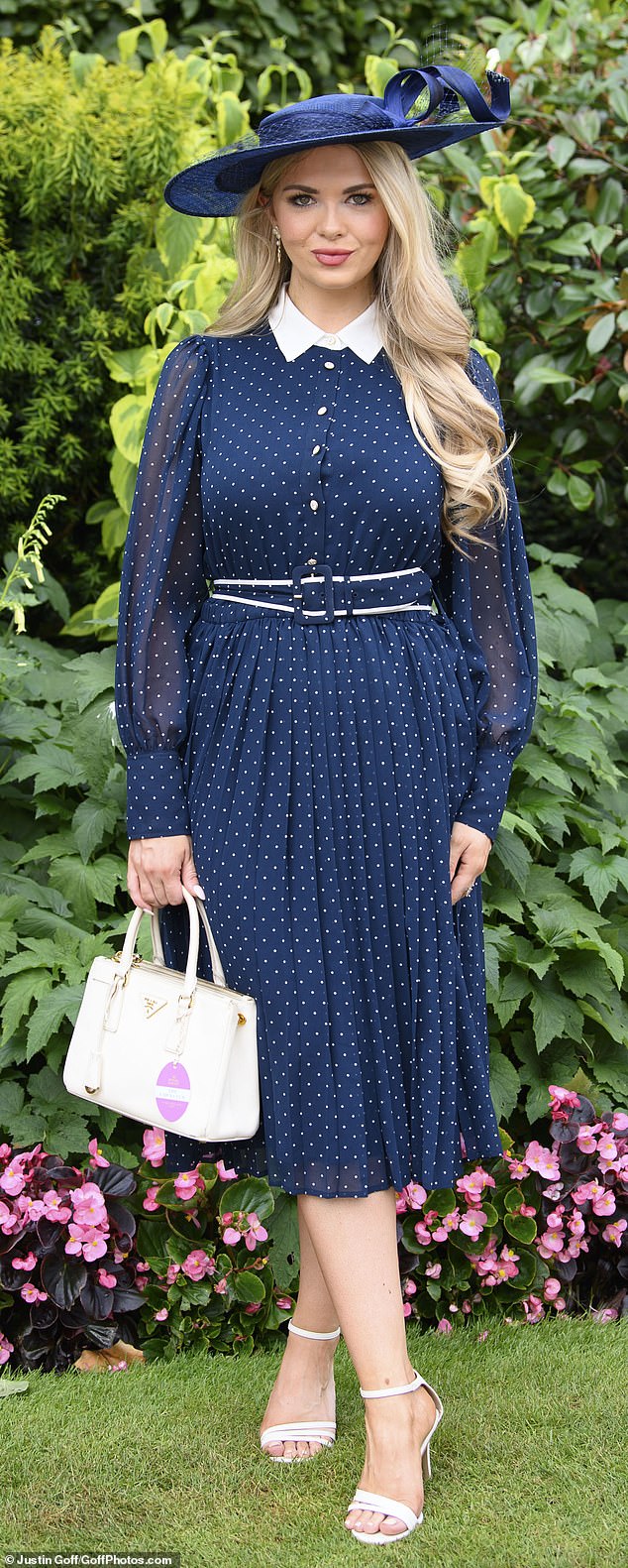 Spots also seemed to be a popular choice of pattern among racegoers, as one woman opted to wear a navy pleated frock with white spots and paired it with a white Prada bag