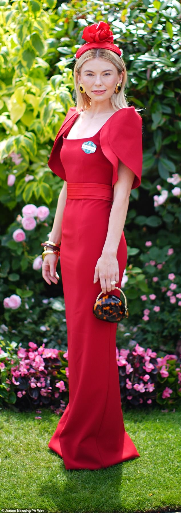 Made in Chelsea star Georgia Toffolo looked glamorous in her cherry red caped gown complete with gold statement earrings