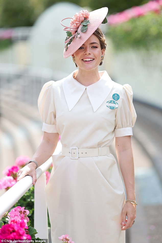 Rosie Turner looked effortlessly elegant as opted for a vintage-esque cream belted dress with a rose fascinator