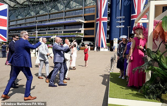 Racegoers beamed as they set off into Ascot racecourse for a day of fun in the sun while taking pictures of their ensembles
