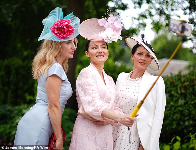 One group was snapped taking pictures of the occasion with a selfie stick as arrived in their best attire