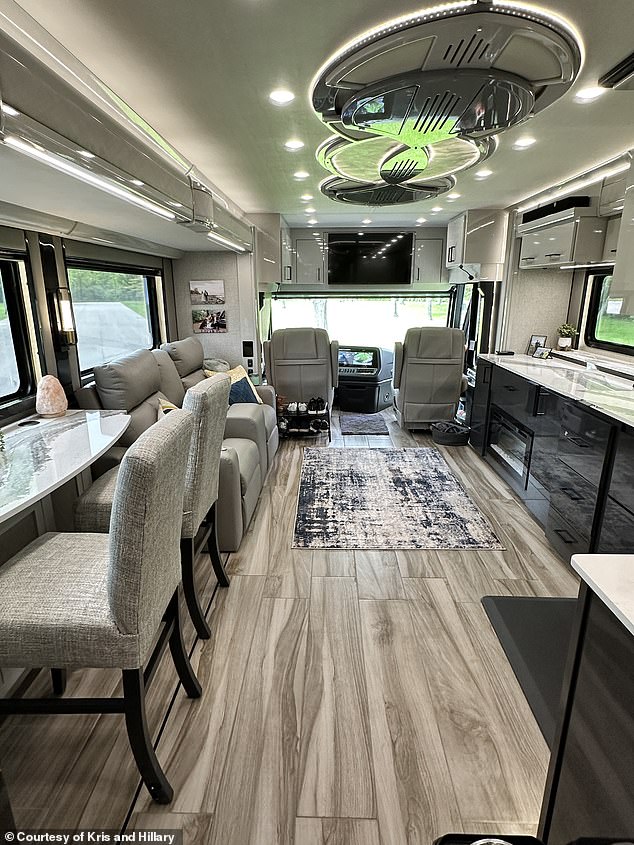 Their 45-foot custom-built luxury American Coach Class A motorhome has a full living room, kitchen, dining area, half-bathroom, bedroom with a king-sized bed, and full-bathroom