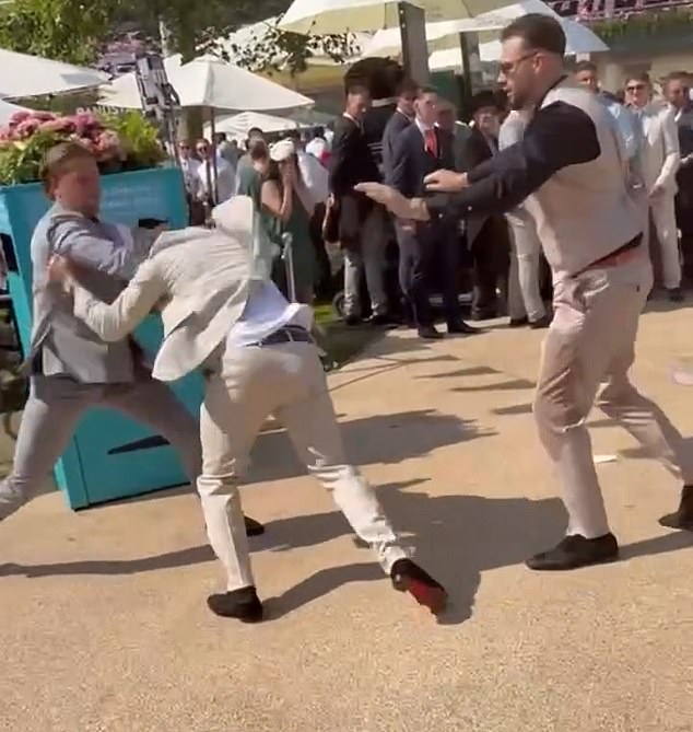A group of men attempting to separate the pair can be heard saying: ''Stop, stop, boys.'