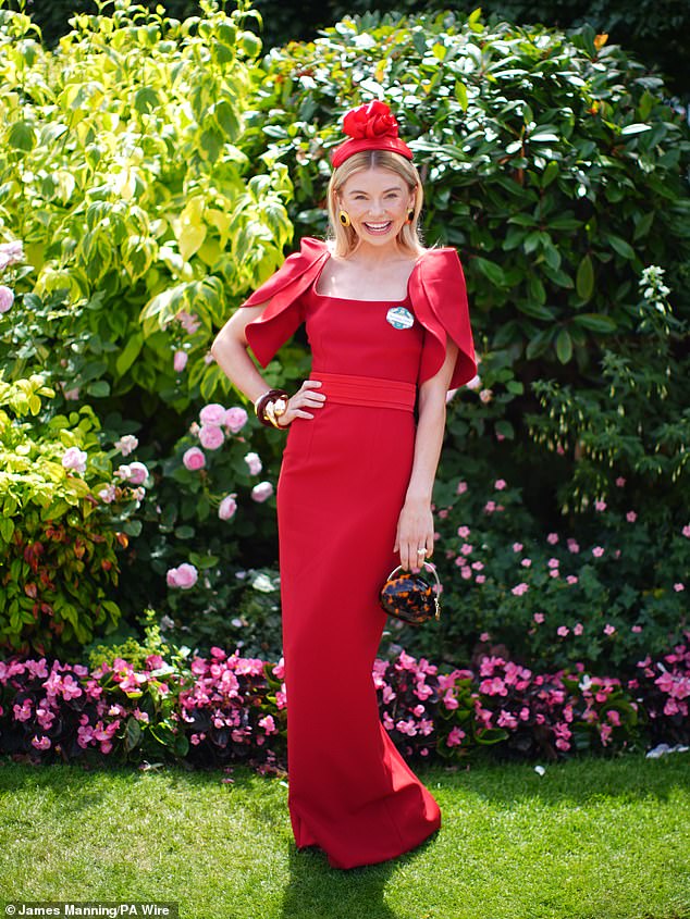 She looked great in the long dress that was cinched in at the waist which she wore with a matching fascinator