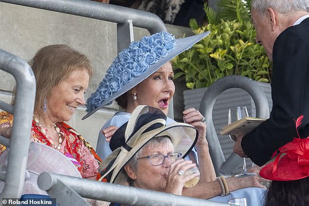 Ms Rowling looked surprised at one point when a guest started speaking to her during the races