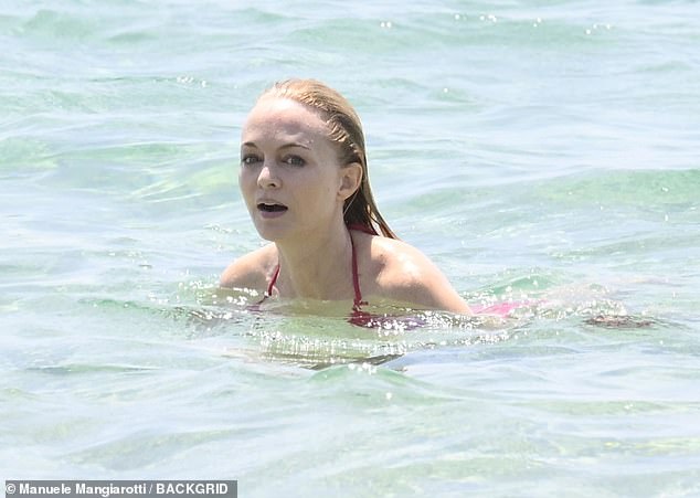 At one point, she dove into the crystal-clear water like she was posing for a swimsuit calendar shoot