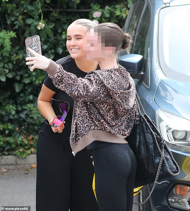 Molly-Mae appeared in great spirits as she shopped in home wear store before stopping to pose for selfies with fans in the carpark