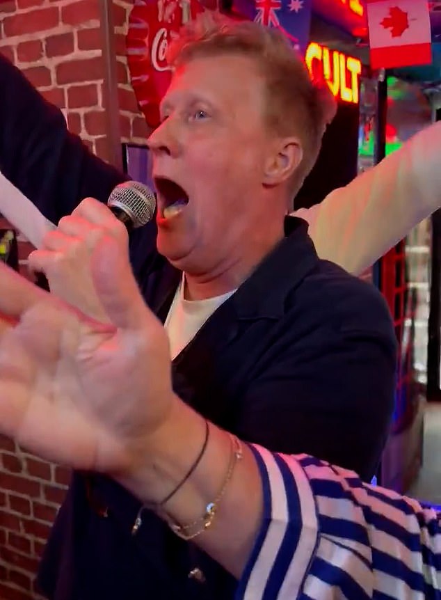 The most soul-stirring moment of all comes at the aria's climax where the partygoers raise their arms high in the air with whoops and cheers as Mr Richards perfectly hits the famous concluding note