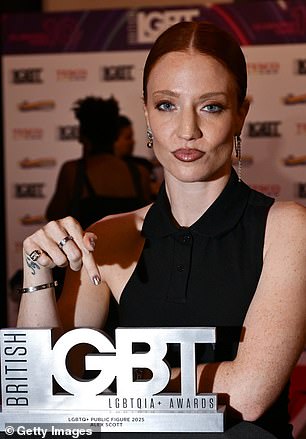 She posed proudly with the gong she accepted on behalf of her partner who was not present
