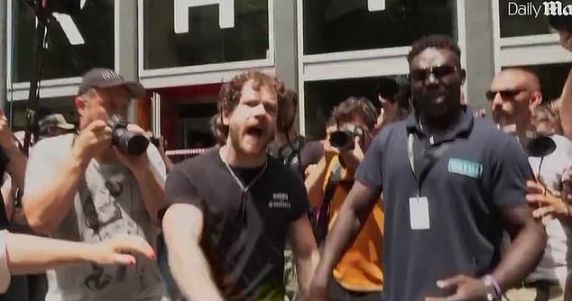 Footage show a furious hotel worker fought back against a crowd of anti-tourism protesters who tried to seal off his workplace in Barcelona