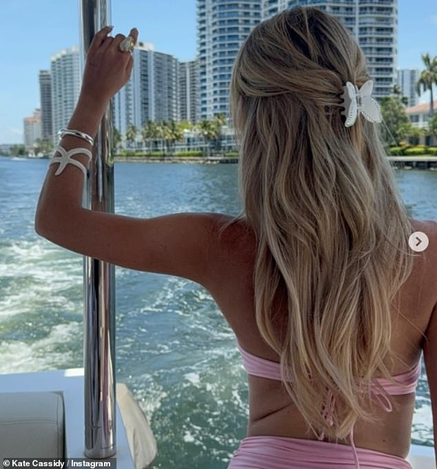 She tied her blonde curly locks away from her face with a pretty flower claw clamp as she accesorised her look with white and silver bracelets