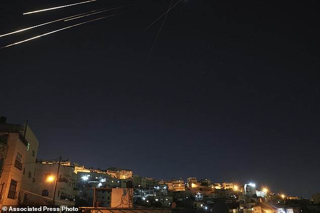 Missiles seen from Jerusalem illuminate the night sky during an Iranian missile attack, early Sunday, June 15, 2025. (AP Photo/Mahmoud Illean)