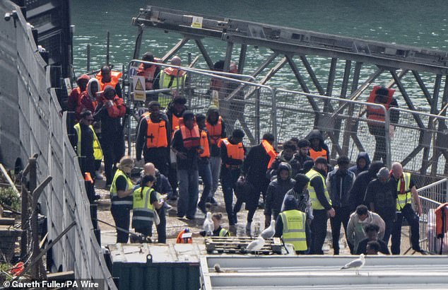 A group of people thought to be migrants are brought in to Dover, Kent, by a Border Force vessel