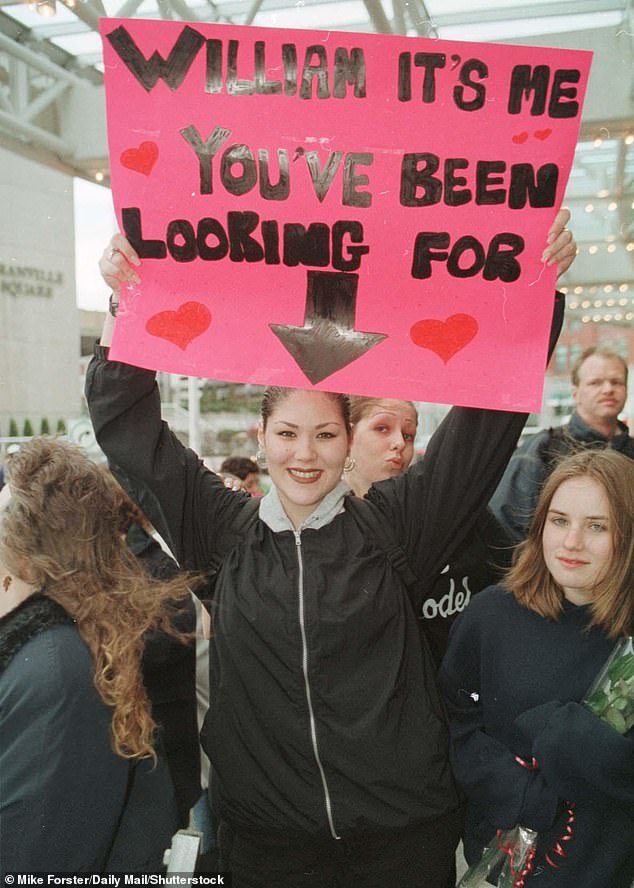 One royal fan is pictured holding a sign which reads: 'William it's me you've been looking for'
