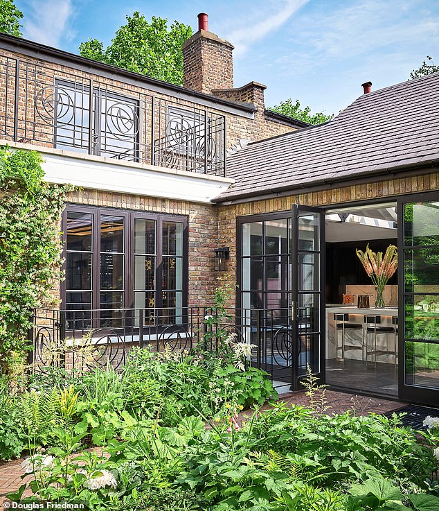 Double doors lead from the kitchen to the garden. The space features Charles Rennie Mackintosh’s custom-made iron railings, which reference his iconic rose design.