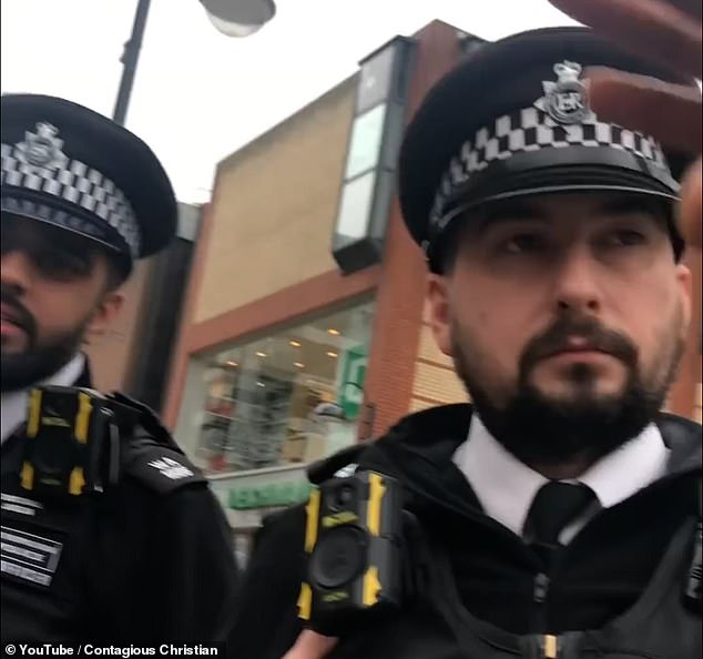 The footage begins with the preacher explaining to the officers what they were preaching