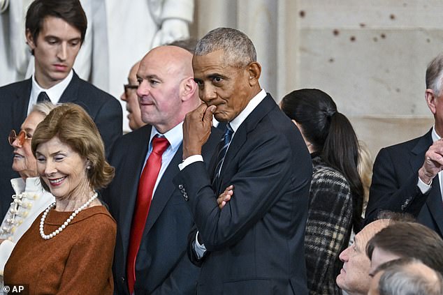 The rumours began after Mr Obama attended several high-profile events - including former president Jimmy Carter's funeral and President Donald Trump's inauguration (pictured), both in January - without his wife