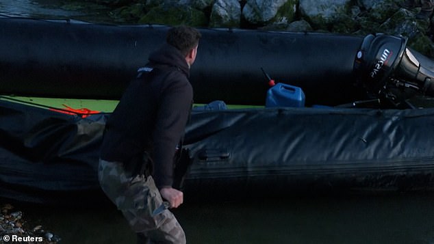 One officer then grabbed a knife and punctured the inflated dinghy, making it unusable