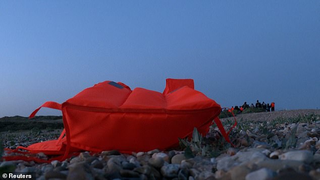 Life jackets were filmed abandoned around the remains of the dinghy as the group left the area