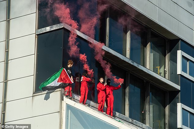 Pictured: activists occupy the roof of the Thales UK arms factory on June 1, 2022 in Glasgow, Scotland. The five protestors unfurled banners and erected flags and ignited pyrotechnics, while two remained at the building overnight and glued themselves to the roof after refusing to engage with police