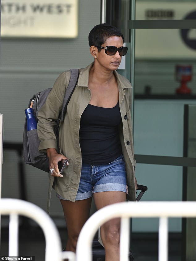 The presenter was seemingly downcast as she wore sunglasses and wheeled a suitcase as she left the building