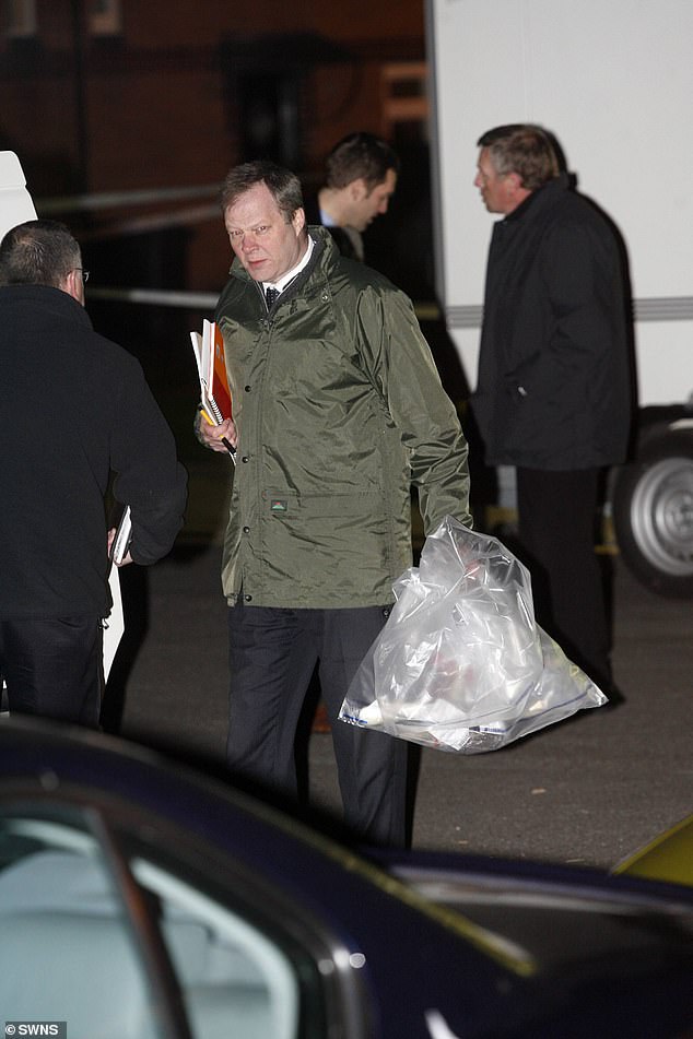 A police officer carries an evidence bag from the scene after Ibrahim was arrested in 2008