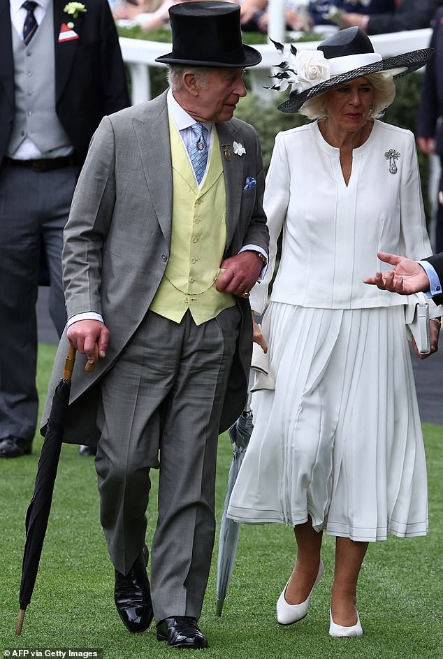 In spite of the sweltering heat, King Charles (pictured, left) donned a traditional three-piece suit and a top hat (see with Queen Camilla, right)
