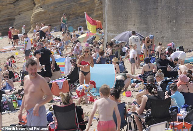 NORTH TYNESIDE: Beachgoers site on deck chairs and play in the sand as they make the most of the heat