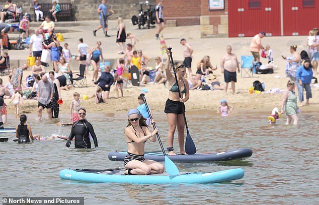 NORTH TYNESIDE: Two young women paddle boarding along the coast on Cullercoats Bay
