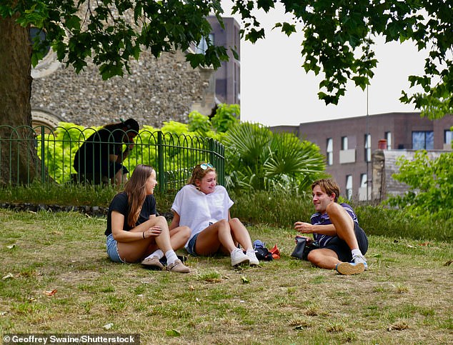 BERKSHIRE: Three young people enjoy a humid afternoon in Forbury Gardens