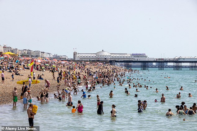 BRIGHTON: Droves of Brits cool down in the sea amid the sweltering heat today